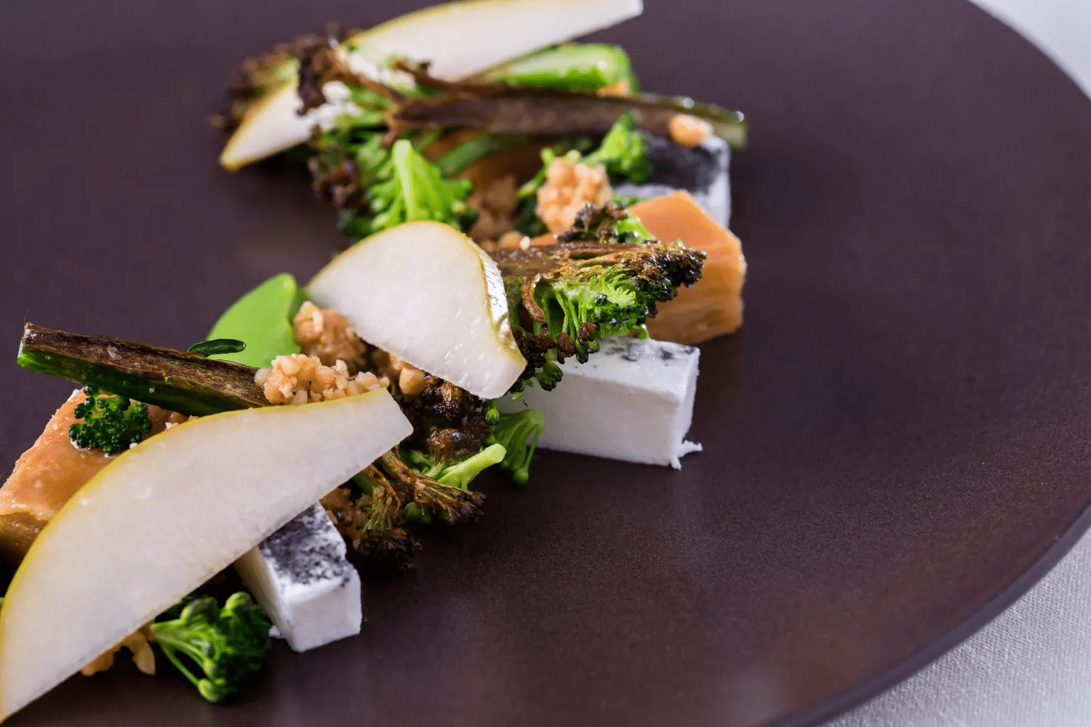 Pink gnocchi with a green core and ricotta cream